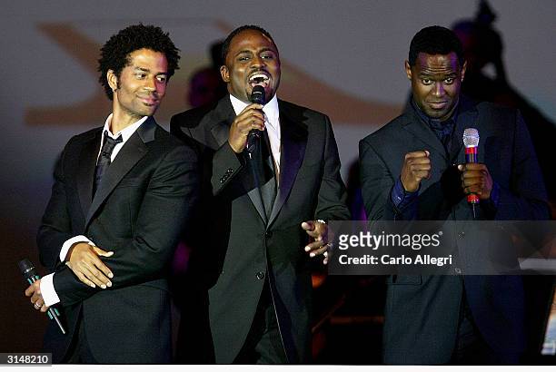 Singer Brian McKnight actor Eric Benet and host/comedian Wayne Brady sing to Muhammad Ali from onstage at 'Celebrity Fight Night X', a charity event...