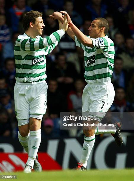 Celtic's Henrik Larsson celebrates scoring the opening goal with team mate Alan Thompson during the Scottish premier league match between Rangers and...