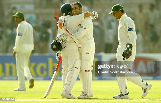 Virender Sehwag is hugged by Sachin Tendulkar of India after Sehwag reached his 200 during day one of the 1st Test Match between Pakistan and India...