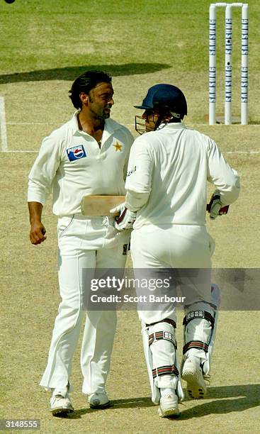 Virender Sehwag of India and Shoaib Akhtar of Pakistan run into each during day one of the 1st Test Match between Pakistan and India at Multan...