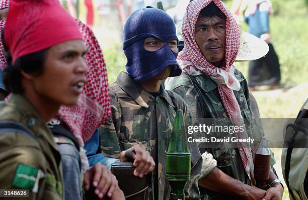 Soldiers of the Moro Islamic Liberation Front stand gaurd at the Islamic Center in Buliok, on March 28, 2004 on the southern island of Mindanao,...