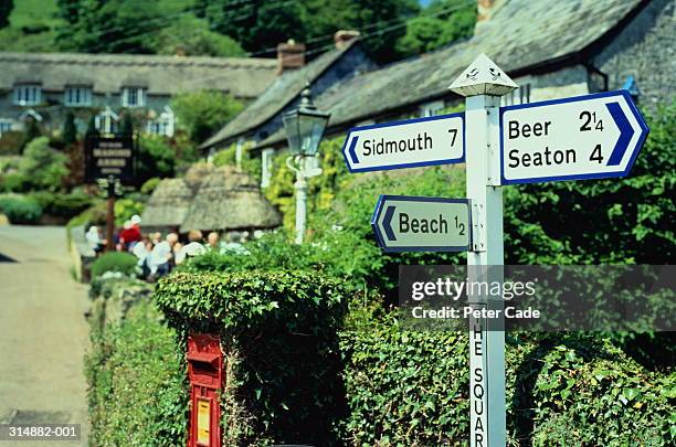 england,devon,near beer, roadsign, public house and letterbox - traffic sign stock pictures, royalty-free photos & images