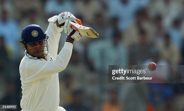 Virender Sehwag of India hits a boundary during day 1 of the 1st Test Match between Pakistan and India at Multan Stadium on March 28, 2004 in Multan,...