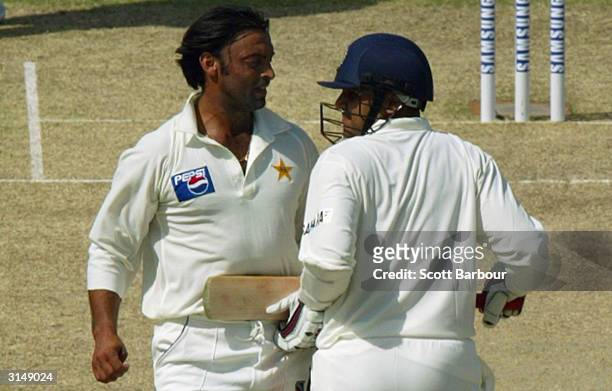 Virender Sehwag of India and Shoaib Akhtar of Pakistan run into each other as Sehwag completes a run during day 1 of the 1st Test Match between...
