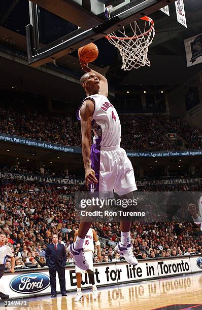 Chris Bosh of the Toronto Raptors completes the one-handed alley-oop against the Memphis Grizzlies on March 28, 2004 at the Air Canada Centre in...