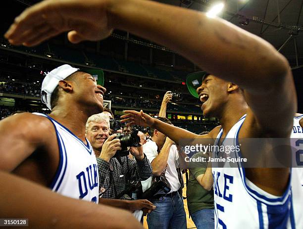 Chris Duhon and Sean Dockery of the Duke Blue Devils hug after Duke defeated the Xavier Muskateers 66-63 to win the fourth round game of the NCAA...