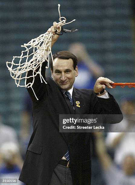 Head coach Mike Krzyzewski of the Duke Blue Devils celebrates his team's 66-63 victory over the Xavier Musketeers and a trip to the Final Four during...