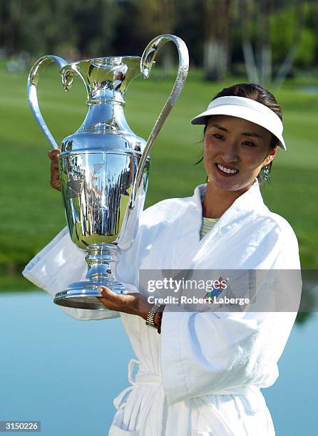 Grace Park of South Korea poses with the Dinah Shore Trophy after Park won the Kraft Nabisco Championship on March 28, 2004 at the Mission Hills...