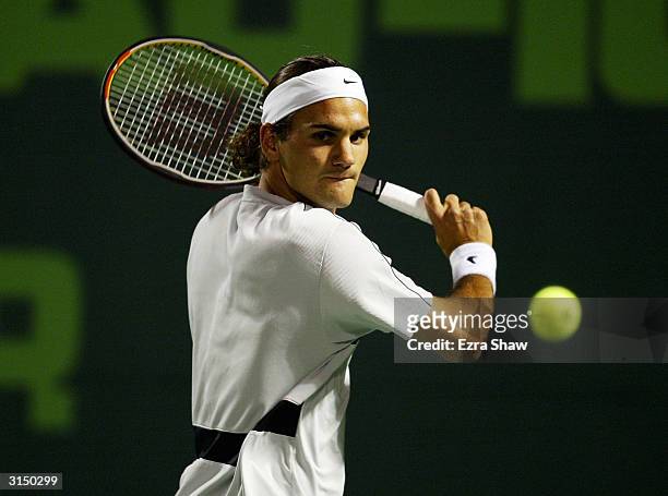 Roger Federer of Switzerland returns a shot against Rafael Nadal of Spain on March 28, 2004 during Nasdaq 100 Open at the Crandon Park Tennis Center...