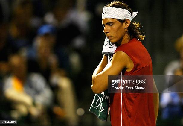 Rafael Nadal of Spain wipes sweat off his face during his match against Roger Federer of Switzerland on March 28, 2004 during Nasdaq 100 Open at the...