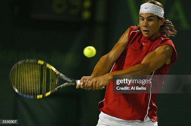 Rafael Nadal of Spain plays a backhand against Roger Federer of Switzerland during The third round of Nasdaq 100 Open on March 28, 2004 in Miami,...
