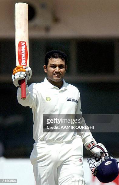 Indian batsman Virender Sehwag celebrates after scoring his triple century during the second day of the first Test match between Pakistan and Indian...