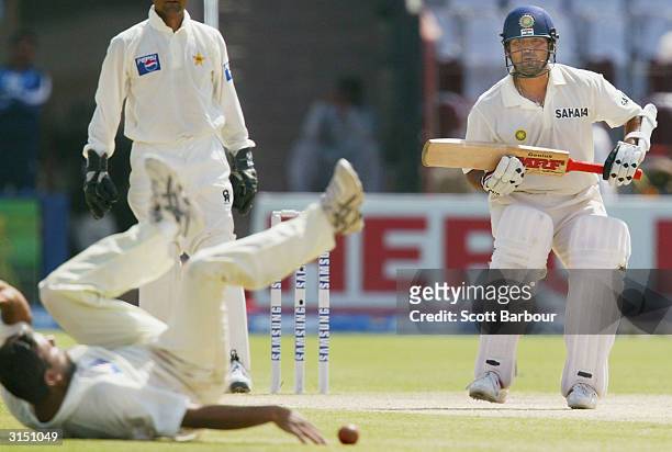 Sachin Tendulkar of India looks for a run as Pakistani bowler Saqlain Mushtaq attempts to stop the ball during day 2 of the 1st Test Match between...