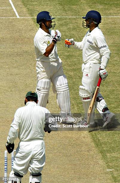 Virender Sehwag and Sachin Tendulkar of India celebrate after Sehwag reached his 300 as wicketkeeper Moin Khan of Pakistan looks down during day 2 of...