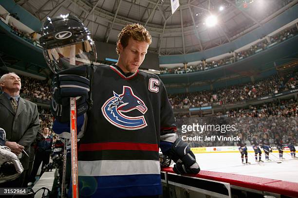 Markus Naslund of the Vancouver Canucks stands in the bench area prior to taking on the Minnesota Wild at General Motors Place on March 10, 2004 in...