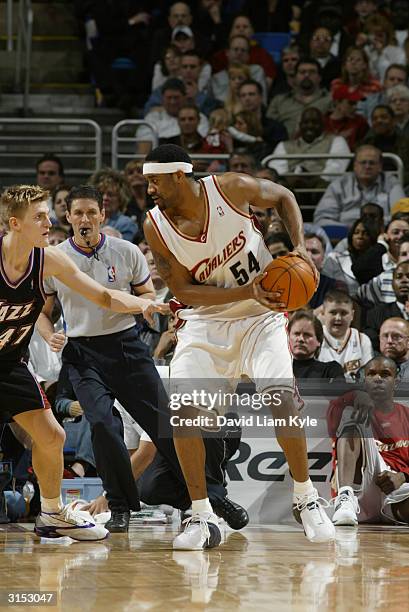 Lee Nailon of the Cleveland Cavaliers posts up Andrei Kirilenko of the Utah Jazz during the game on March 19, 2004 at Gund Arena in Cleveland, Ohio....