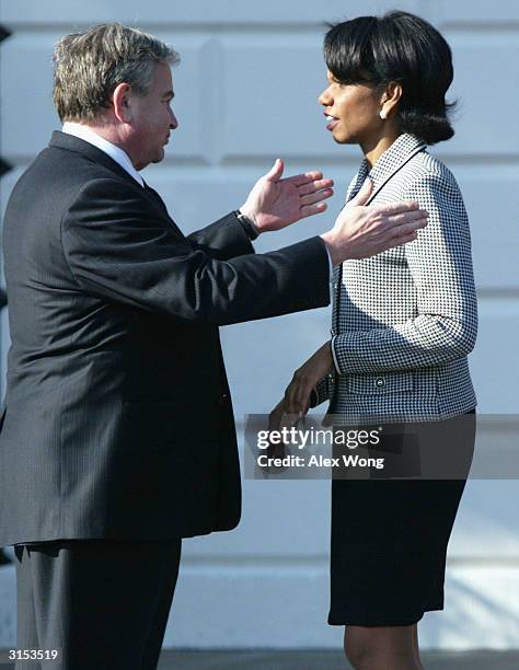 White House Security Advisor Condoleezza Rice talks to former White House Security Advisor Sandy Berger after a welcoming ceremony March 29, 2004 at...