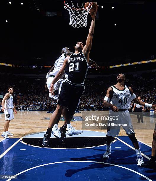 Tim Duncan of the San Antonio Spurs goes in for a layup during a game against the Minnesota Timberwolves at Target Center on March 23, 2004 in...