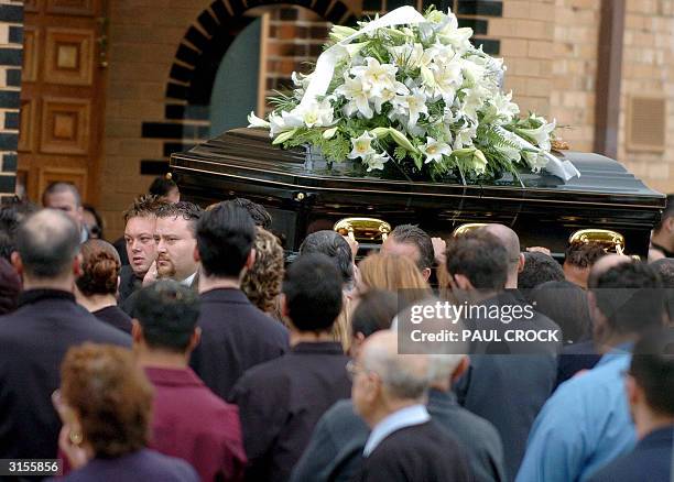 Australian underworld figure and accused drug trafficer, Carl Williams , helps carry the casket of his murdered friend and bodyguard, Andrew 'Benji'...