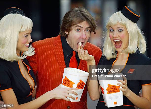 Jonathan Ross poses with twin usherettes to launch "Orange Wednesdays", a 'two-for-the price-of-one' cinema initiative launched at the Odeon Cinema,...