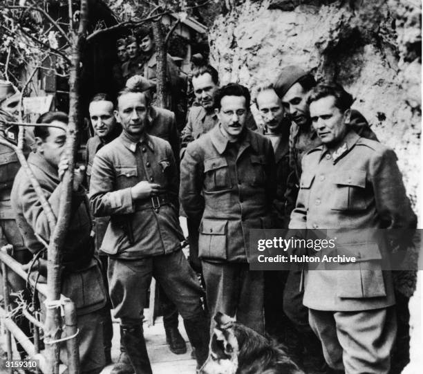 Yugoslavian leader Marshall Josip Broz Tito and his staff pose with Chetnik leader Dragoljub 'Drazha' Mihailovic at his secret mountain retreat,...
