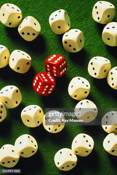 pair of red dice showing 'sixes' on each side, among white dice - pair stock photos et images de collection