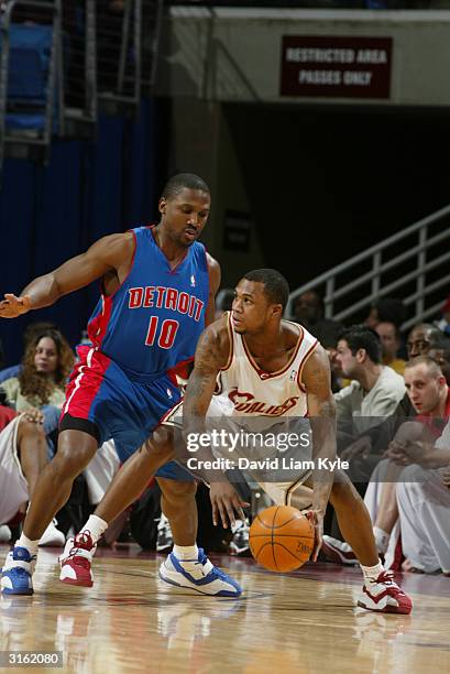 Dajuan Wagner of the Cleveland Cavaliers is defended by Lindsey Hunter of the Detroit Pistons during the game at Gund Arena on March 21, 2004 in...