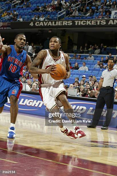 Dajuan Wagner of the Cleveland Cavaliers drives around Lindsey Hunter of the Detroit Pistons during the game at Gund Arena on March 21, 2004 in...