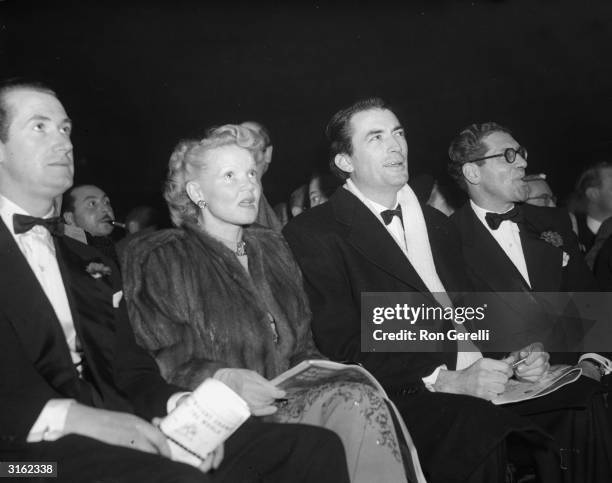 American actor Gregory Peck and his first wife Greta attend a boxing match between Freddie Mills and Joey Maxim at Earl's Court, London.