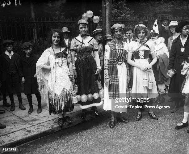 Pierrot clown with women dressed as gypsies at the Camberwell peace carnival in south London.