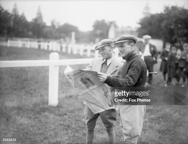Two jockeys, Michael Beary and Billy Nevett reading the race card at Royal Ascot.