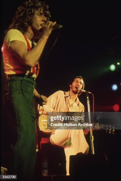 Roger Daltrey and Pete Townshend of The Who playing in concert.