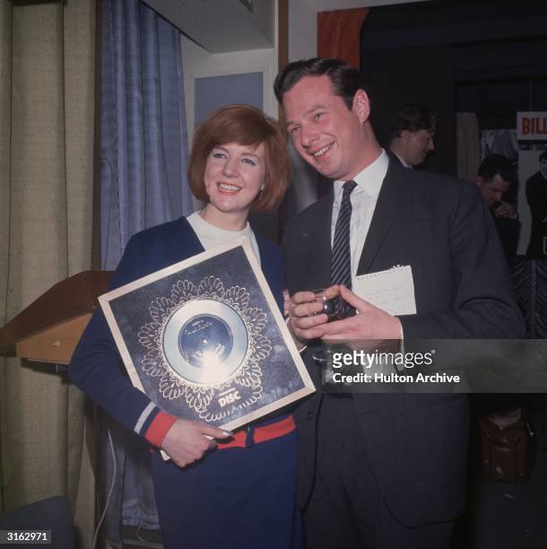 Pop singer Cilla Black with managerand promoter Brian Epstein . She is holding the Silver Disc for her record, 'Anyone who had a Heart'