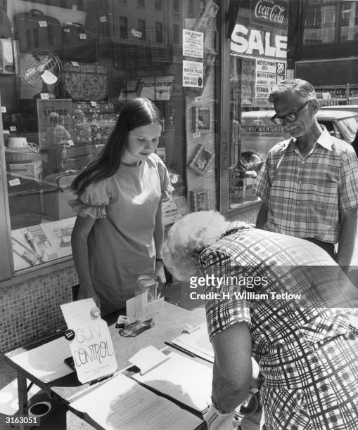 Lisa Adams at her stall in Lexington Avenue, New York, where she encourages passers by to sign a petition organised by the Emergency Committee for...