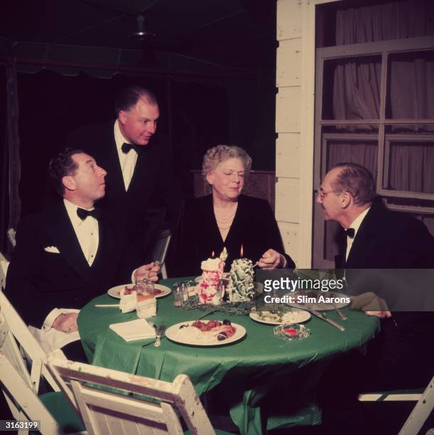 Enjoying a meal outdoors at the Bogart's house in Beverly Hills. From l to r, David Chasen, Sam Colt , his mother actress Ethel Barrymore and...