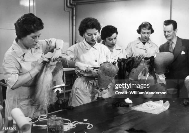Trainee hairdressers Susan Shepherd of Whitton, Maureen Richard of London, Pamela Wright of Leeds and Jill Blackwood of St Annes on Sea practice some...