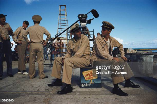 Director John Ford talks to an actor while film stars Henry Fonda and Jack Lemmon take a break during the shooting of Warner Brothers' 'Mister...