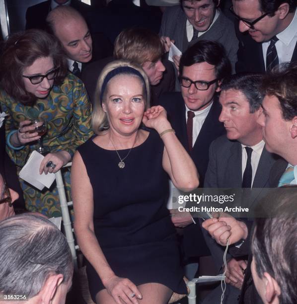 Wearing a little black number, film star and World War II pin-up Betty Grable at a press reception in London.