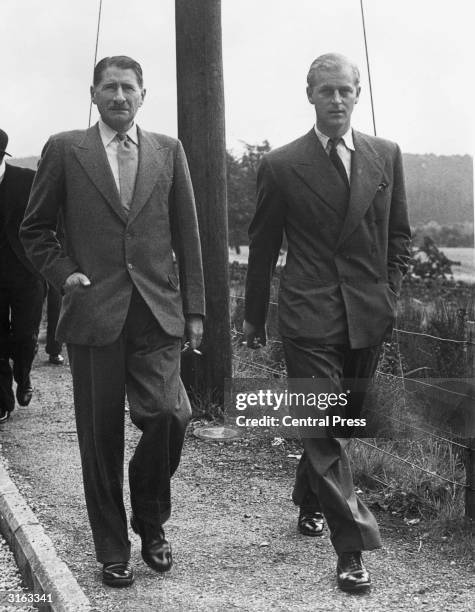 Prince Philip of Greece leaving Crathie Church at Balmoral with Michael Bowes-Lyon, brother of Queen Elizabeth, consort to King George.