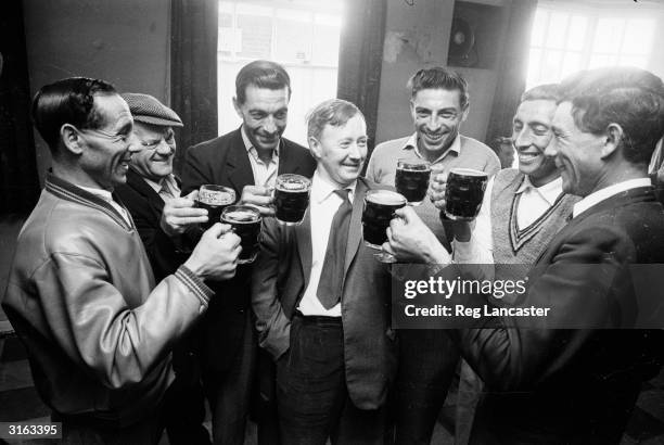 Group of men from the Atlantic Island of Tristan da Cunha gather for a pint at the local before leaving England.