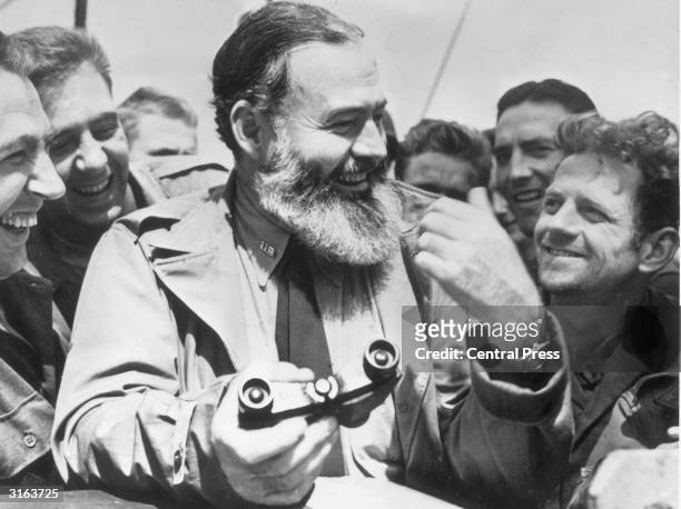 American writer Ernest Hemingway travelling with US soldiers, in his capacity as war correspondent, on their way to Normandy for the D-Day landings.
