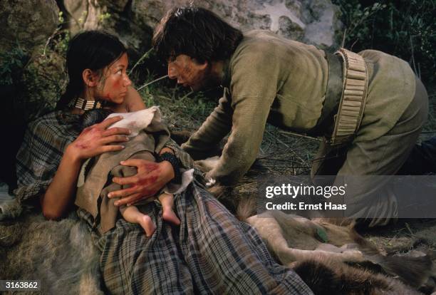 Dustin Hoffman finds a Native American girl, played by Aimee Eccles, giving birth to a baby in a scene from 'Little Big Man', directed by Arthur Penn.