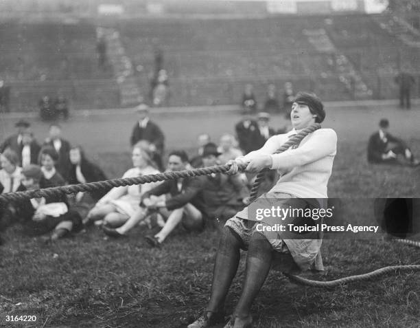 Contestants taking the strain in a tug of war during waitresses sports at Stamford Bridge in Chelsea, London.