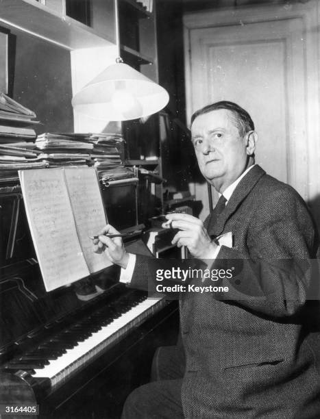 French composer Georges Auric at the piano, his work ranges from orchestral pieces to ballets to film scores.
