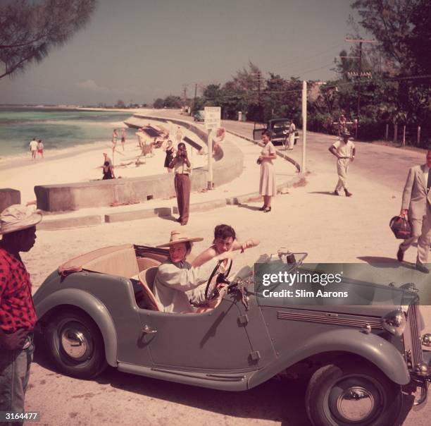 American film star Katharine Hepburn driving along the waterfront with Irene Mayer Selznick at Montego Bay, Jamaica.