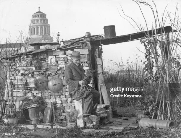 Man living in a homemade shack in the poor barracks outside Milan after losing his home in a bombing raid.