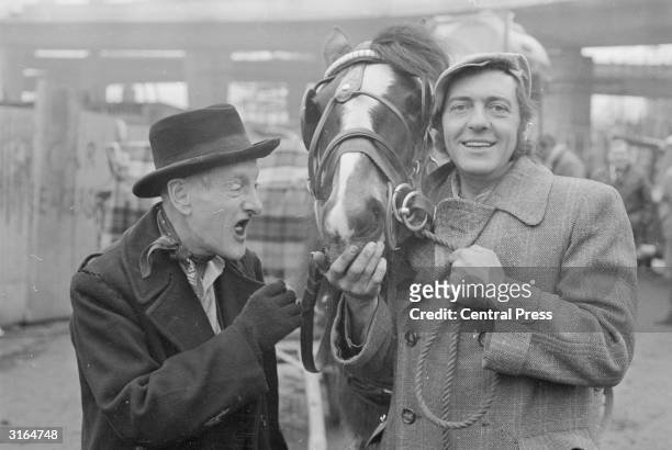 Harry H Corbett and Wilfrid Brambell , stars of the popular TV series 'Steptoe and Son', with their carthorse 'Hercules'.