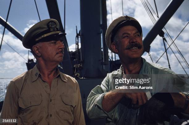 Actors William Powell as Doc and on the right, Ward Bond as CPO Dawdy in a scene from Mister Roberts filming on location in Hawaii.