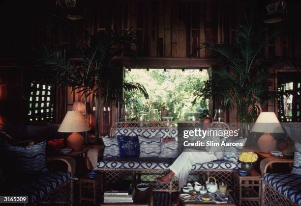 Dress designer Oscar De La Renta relaxes in the living room of his apartment the Casa de Madera in the resort of Casa de Campo in the Dominican...