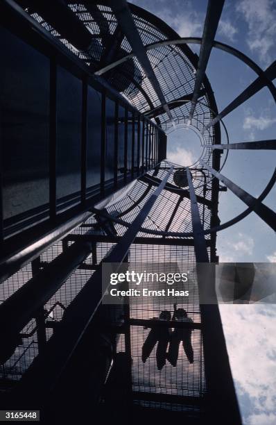 Worms-eye-view of construction workers on a nearly completed building in New York.